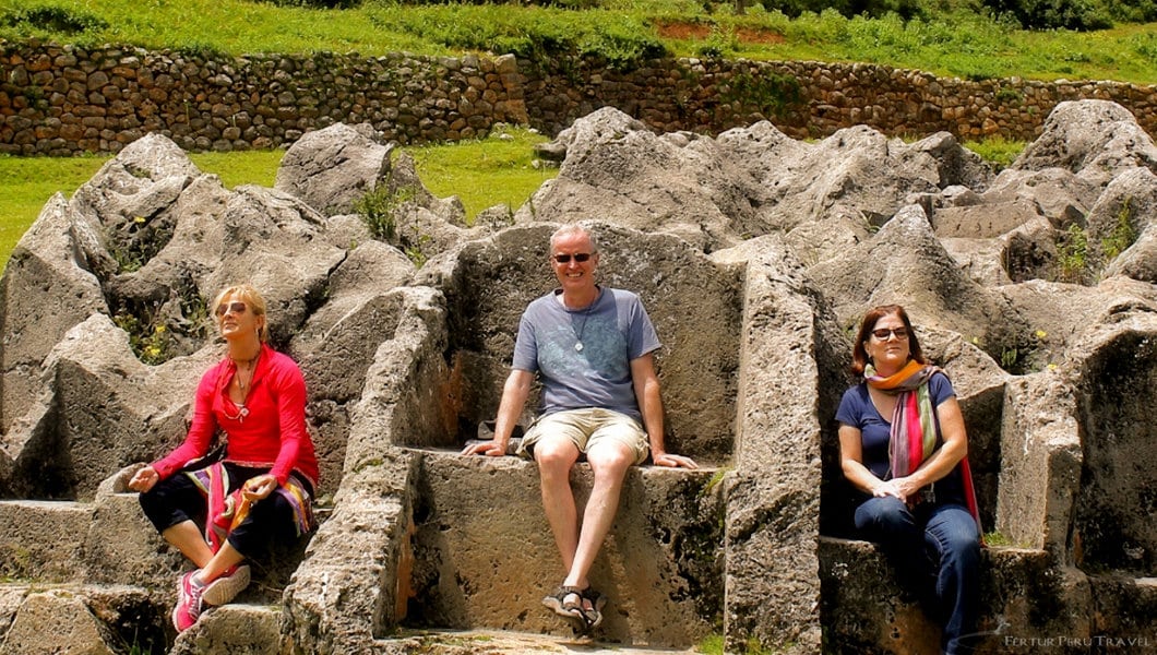 Fertur Peru Travel clients seated on the Inca stone thrones at the Temple of Lightning in Cusco